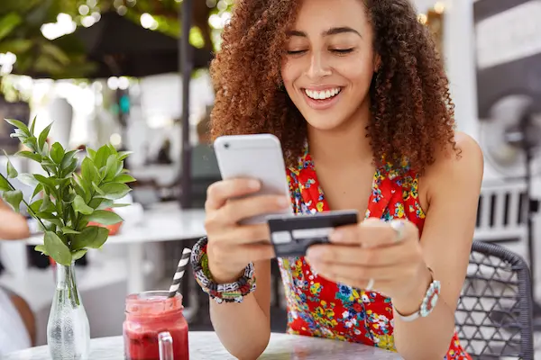 women using phone and card